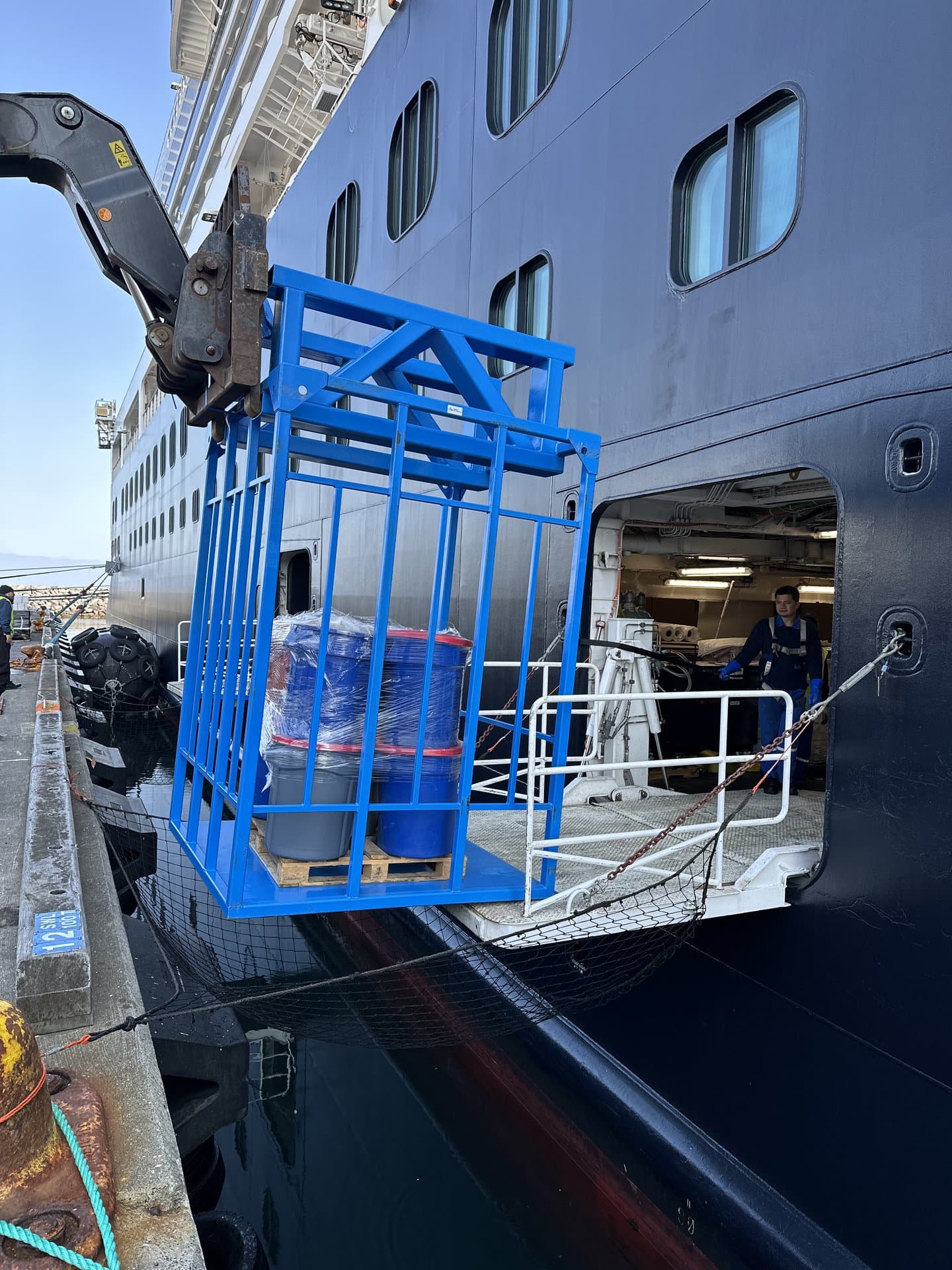 Luggage cage being lifted to vessel